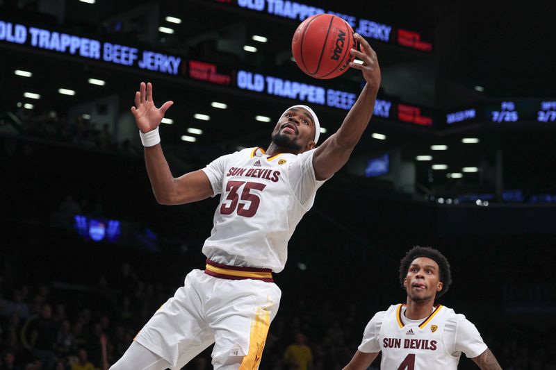 Nov 17, 2022; Brooklyn, New York, USA; Arizona State Sun Devils guard Devan Cambridge (35) rebounds in front of  guard Desmond Cambridge Jr. (4) during the first half against the Michigan Wolverines at Barclays Center. Mandatory Credit: Vincent Carchietta-USA TODAY Sports