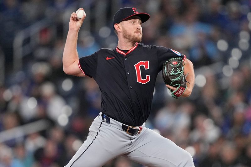 May 4, 2025; Toronto, Ontario, CAN; Cleveland Guardians starting pitcher Tanner Bibee (28) pitches to the Toronto Blue Jays during the first inning at Rogers Centre. Mandatory Credit: John E. Sokolowski-Imagn Images