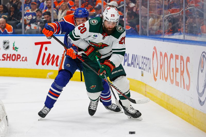 Dec 8, 2023; Edmonton, Alberta, CAN; Edmonton Oilers forward Mattias Janmark (13) and Minnesota Wild forward Pat Maroon (20) battle for a loose puck during the second period at Rogers Place. Mandatory Credit: Perry Nelson-USA TODAY Sports