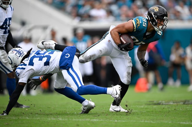 Jacksonville Jaguars' Brenton Strange (85) runs against Indianapolis Colts' Chris Lammons (35 during the first half of an NFL football game, Sunday, Oct. 6, 2024, in Jacksonville, Fla. (AP Photo/Phelan M. Ebenhack)