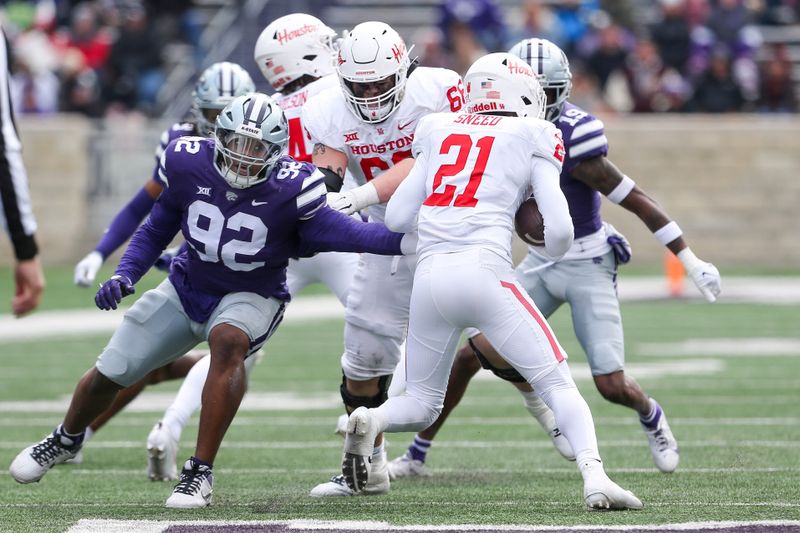 Oct 28, 2023; Manhattan, Kansas, USA; Kansas State Wildcats defensive tackle Jevon Banks (92) tries to tackle Houston Cougars running back Stacy Sneed (21) during the fourth quarter at Bill Snyder Family Football Stadium. Mandatory Credit: Scott Sewell-USA TODAY Sports