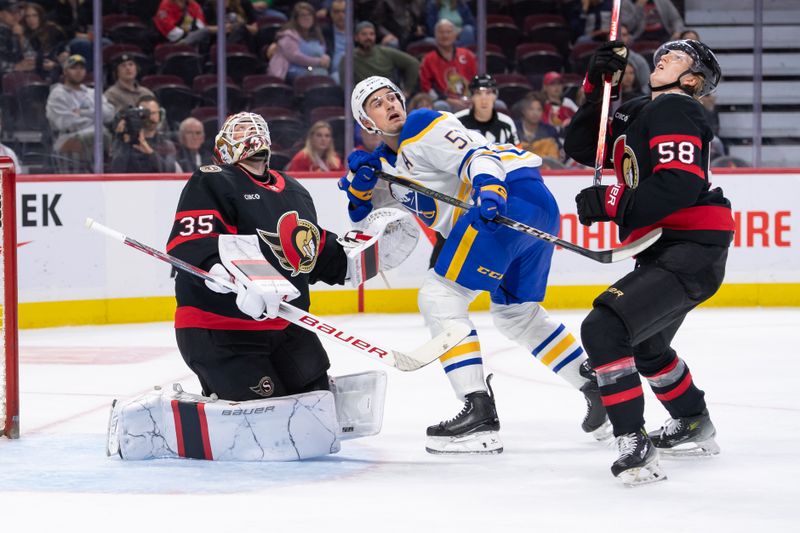 Sep 26, 2024; Ottawa, Ontario, CAN; Ottawa Senators goalie Linus Ullmark (35) and defenseman Carter Yakemchuk (58) follow the puck after a shot from Buffalo Sabres left wing Brett Murray (57) gets airborne in the second period at the Canadian Tire Centre. Mandatory Credit: Marc DesRosiers-Imagn Images