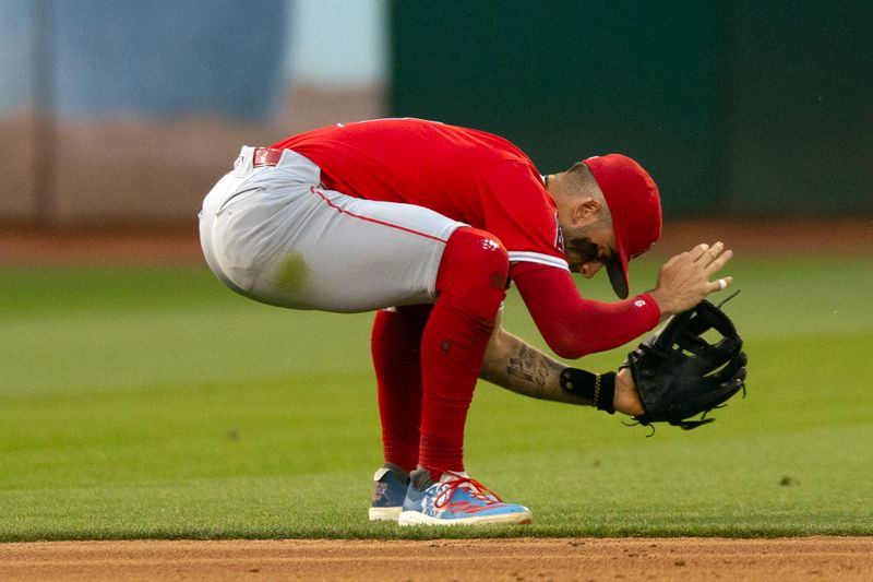 Jul 3, 2024; Oakland, California, USA; Los Angeles Angels shortstop Zach Neto (9) reacts after he cannot snare an RBI single by Oakland Athletics third baseman Brett Harris during the sixth inning at Oakland-Alameda County Coliseum. Mandatory Credit: D. Ross Cameron-USA TODAY Sports