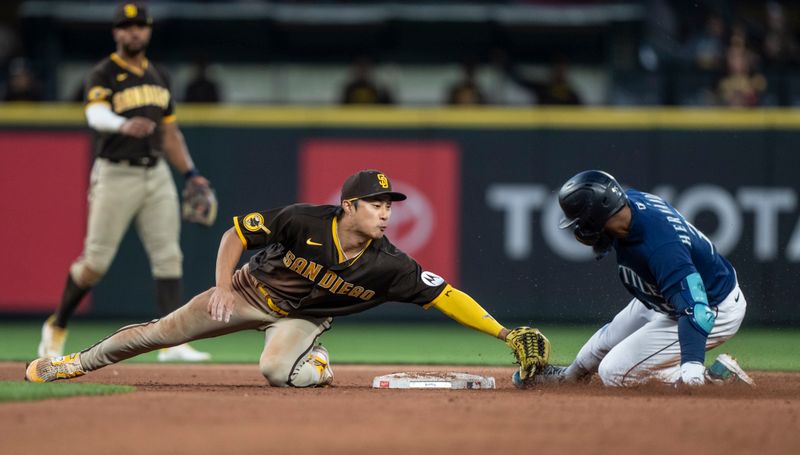 Aug 9, 2023; Seattle, Washington, USA; San Diego Padres second baseman Ha-Seong Kim (7) tags out Seattle Mariners right fielder Teoscar Hernandez (35) at second during the sixth inning at T-Mobile Park. Mandatory Credit: Stephen Brashear-USA TODAY Sports