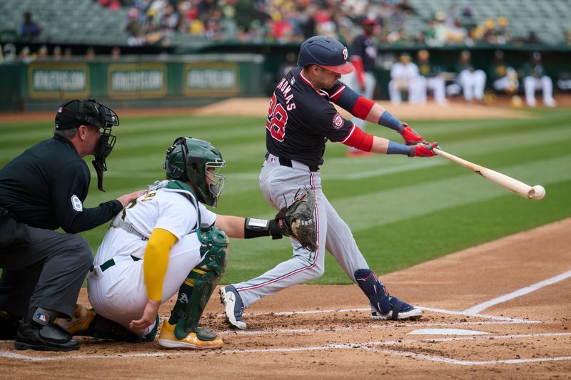 Apr 14, 2024; Oakland, California, USA; Washington Nationals outfielder Lane Thomas (28) bats against the Oakland Athletics during the first inning at Oakland-Alameda County Coliseum. Mandatory Credit: Robert Edwards-USA TODAY Sports