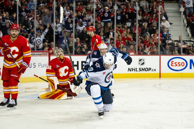 Oct 20, 2025; Calgary, Alberta, CAN; Winnipeg Jets center Jonathan Toews (19) celebrates after scoring a goal on Calgary Flames goaltender Dustin Wolf (32) during the third period at Scotiabank Saddledome. Mandatory Credit: Brett Holmes-Imagn Images