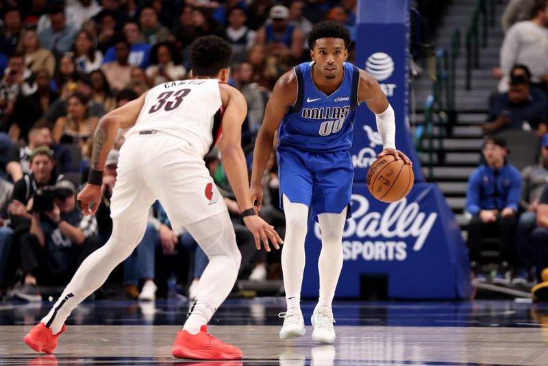 DALLAS, TEXAS - JANUARY 05: Brandon Williams #00 of the Dallas Mavericks dribbles the ball up court against Toumani Camara #33 of the Portland Trail Blazers in the second half at American Airlines Center on January 05, 2024 in Dallas, Texas. NOTE TO USER: User expressly acknowledges and agrees that, by downloading and or using this photograph, User is consenting to the terms and conditions of the Getty Images License Agreement. (Photo by Tim Heitman/Getty Images)