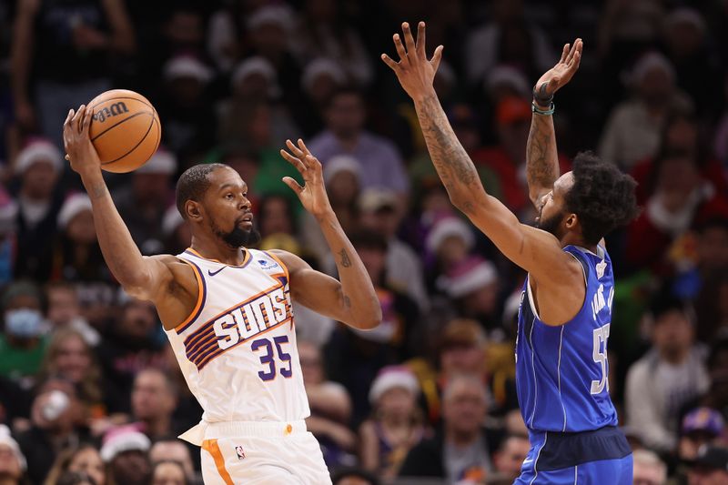 PHOENIX, ARIZONA - DECEMBER 25: Kevin Durant #35 of the Phoenix Suns handles the ball against Derrick Jones Jr. #55 of the Dallas Mavericks during the first half of the NBA game at Footprint Center on December 25, 2023 in Phoenix, Arizona. NOTE TO USER: User expressly acknowledges and agrees that, by downloading and or using this photograph, User is consenting to the terms and conditions of the Getty Images License Agreement.  (Photo by Christian Petersen/Getty Images)