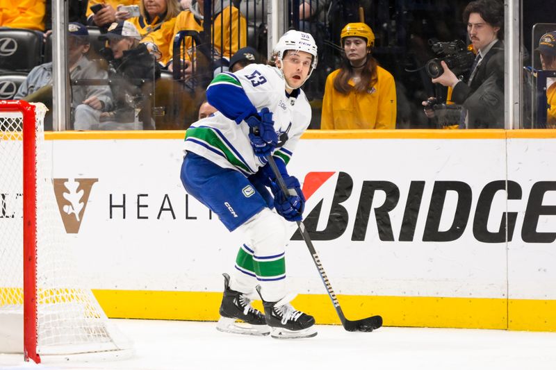 Jan 29, 2025; Nashville, Tennessee, USA;  Vancouver Canucks center Teddy Blueger (53) skates behind the net against the Nashville Predators during the second period at Bridgestone Arena. Mandatory Credit: Steve Roberts-Imagn Images