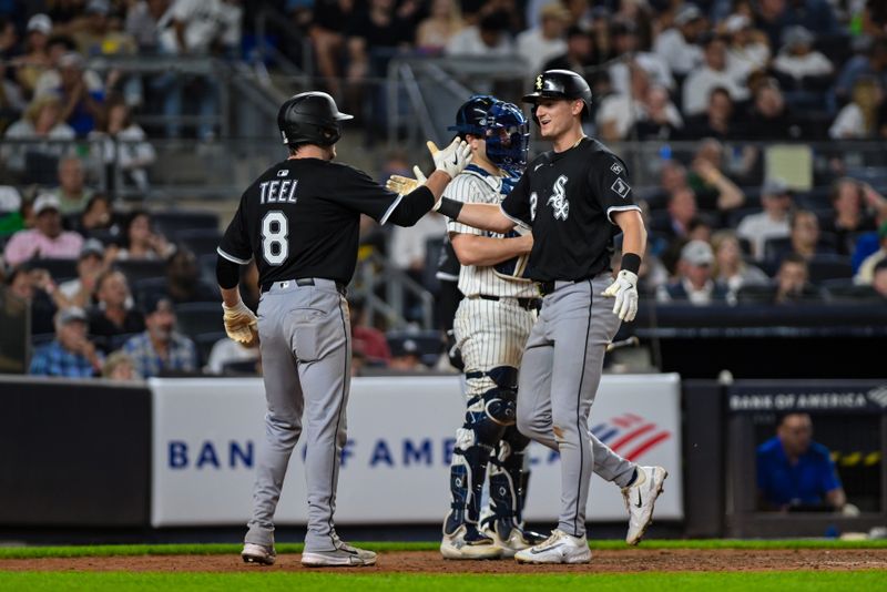 Sep 23, 2025; Bronx, New York, USA; Chicago White Sox shortstop Colson Montgomery (12) is greeted at home plate by catcher Kyle Teel (8) after hitting a two run home run against the New York Yankees during the sixth inning at Yankee Stadium. Mandatory Credit: John Jones-Imagn Images