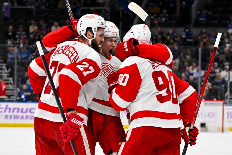 Dec 12, 2023; St. Louis, Missouri, USA;  Detroit Red Wings center Michael Rasmussen (27) is congratulated by defenseman Moritz Seider (53) and center Joe Veleno (90) after scoring against the St. Louis Blues during the third period at Enterprise Center. Mandatory Credit: Jeff Curry-USA TODAY Sports