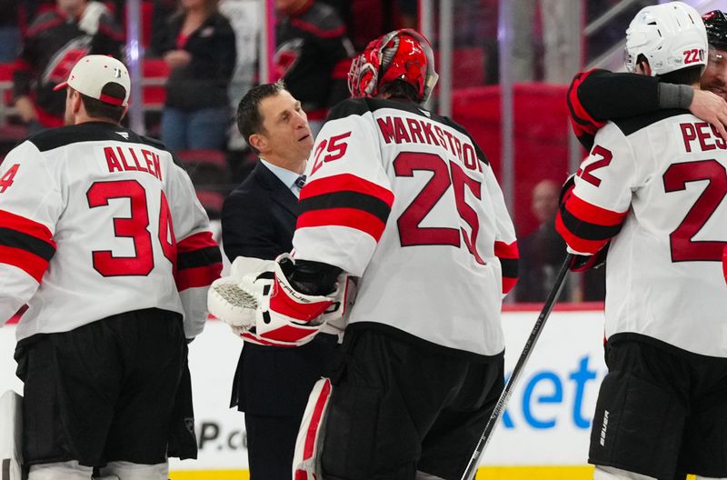Apr 29, 2025; Raleigh, North Carolina, USA; Carolina Hurricanes tead coach Rod Brind’Amour shakes hands with New Jersey Devils goaltender Jacob Markstrom (25) after their win in the second overtime in game five of the first round of the 2025 Stanley Cup Playoffs at Lenovo Center. Mandatory Credit: James Guillory-Imagn Images