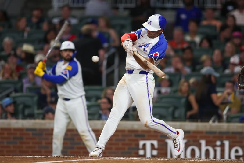 Aug 24, 2024; Atlanta, Georgia, USA; Atlanta Braves first baseman Matt Olson (28) hits a RBI double against the Washington Nationals in the sixth inning at Truist Park. Mandatory Credit: Brett Davis-USA TODAY Sports
