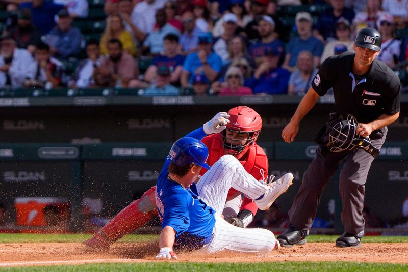 Feb 27, 2025; Mesa, Arizona, USA; Los Angeles Angels catcher Juan Flores (99) tags out Chicago Cubs infielder James Triantos (95) at home base in the sixth inning during a spring training game at Sloan Park. Mandatory Credit: Allan Henry-Imagn Images