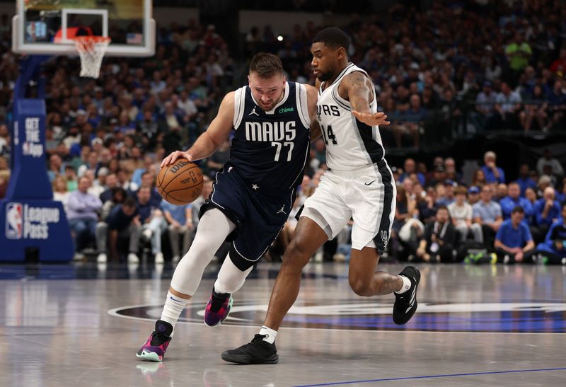 DALLAS, TEXAS - OCTOBER 24: Luka Doncic #77 of the Dallas Mavericks drives against Blake Wesley #14 of the San Antonio Spurs during the second quarter at American Airlines Center on October 24, 2024 in Dallas, Texas.  NOTE TO USER: User expressly acknowledges and agrees that, by downloading and or using this photograph, User is consenting to the terms and conditions of the Getty Images License Agreement. (Photo by Sam Hodde/Getty Images)