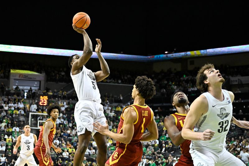 Mar 1, 2025; Eugene, Oregon, USA; Oregon Ducks guard TJ Bamba (5) shoots the ball over USC Trojans guard Desmond Claude (1) during the first half at Matthew Knight Arena. Mandatory Credit: Craig Strobeck-Imagn Images