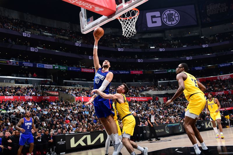 LOS ANGELES, CA - MARCH 25: Ivica Zubac #40 of the LA Clippers drives to the basket during the game against the Indiana Pacers on March 25, 2024 at Crypto.Com Arena in Los Angeles, California. NOTE TO USER: User expressly acknowledges and agrees that, by downloading and/or using this Photograph, user is consenting to the terms and conditions of the Getty Images License Agreement. Mandatory Copyright Notice: Copyright 2024 NBAE (Photo by Adam Pantozzi/NBAE via Getty Images)