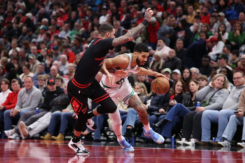 CHICAGO, ILLINOIS - NOVEMBER 29: Jayson Tatum #0 of the Boston Celtics dribbles the ball against Lonzo Ball #2 of the Chicago Bulls during the first quarter of the Emirates NBA Cup game at the United Center on November 29, 2024 in Chicago, Illinois. NOTE TO USER: User expressly acknowledges and agrees that, by downloading and or using this photograph, User is consenting to the terms and conditions of the Getty Images License Agreement.  (Photo by Luke Hales/Getty Images)