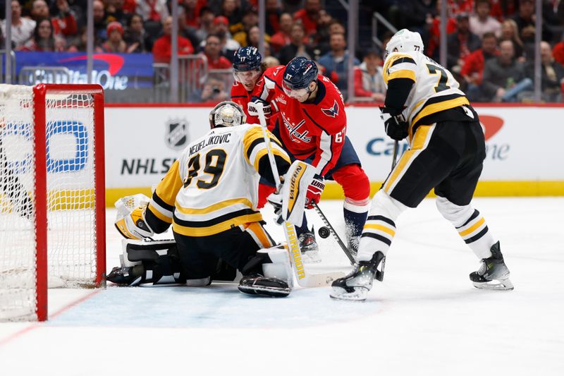 Apr 4, 2024; Washington, District of Columbia, USA; Pittsburgh Penguins goaltender Alex Nedeljkovic (39) makes a save on Washington Capitals left wing Max Pacioretty (67) in the third period at Capital One Arena. Mandatory Credit: Geoff Burke-USA TODAY Sports