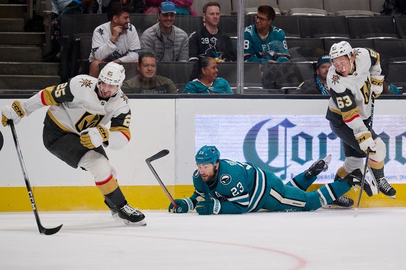 Sep 26, 2025; San Jose, California, USA; Vegas Golden Knights center Matyas Sapovaliv (25) and right wing Ben Hemmerling (63) defend against San Jose Sharks center Barclay Goodrow (23) along the boards during the second period at SAP Center at San Jose. Mandatory Credit: Robert Edwards-Imagn Images