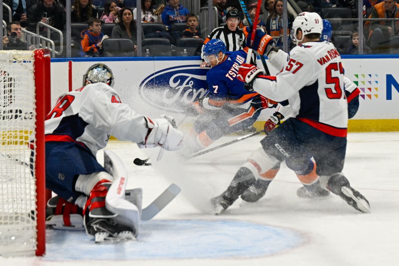 Nov 30, 2025; Elmont, New York, USA;  New York Islanders right wing Maxim Tsyplakov (7) makes a move towards the net defended by Washington Capitals defenseman Trevor van Riemsdyk (57) during the second period at UBS Arena. Mandatory Credit: Dennis Schneidler-Imagn Images
