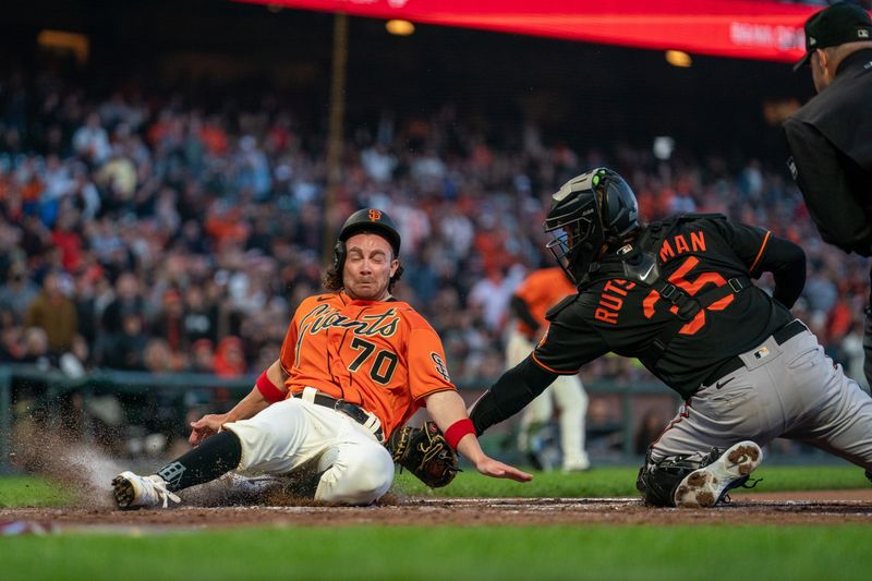 Jun 2, 2023; San Francisco, California, USA;  San Francisco Giants center fielder Brett Wisely (70) is tagged out by Baltimore Orioles catcher Adley Rutschman (35) during the third inning at Oracle Park. Mandatory Credit: Neville E. Guard-USA TODAY Sports