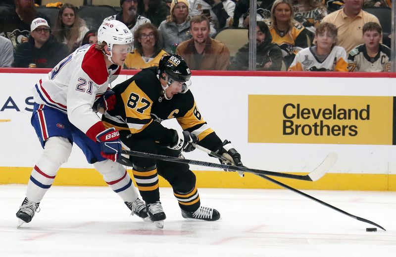 Nov 2, 2024; Pittsburgh, Pennsylvania, USA;  Pittsburgh Penguins center Evgeni Malkin (71) moves the puck against pressure from Montreal Canadiens defenseman Kaiden Guhle (21) during the third period at PPG Paints Arena. Mandatory Credit: Charles LeClaire-Imagn Images