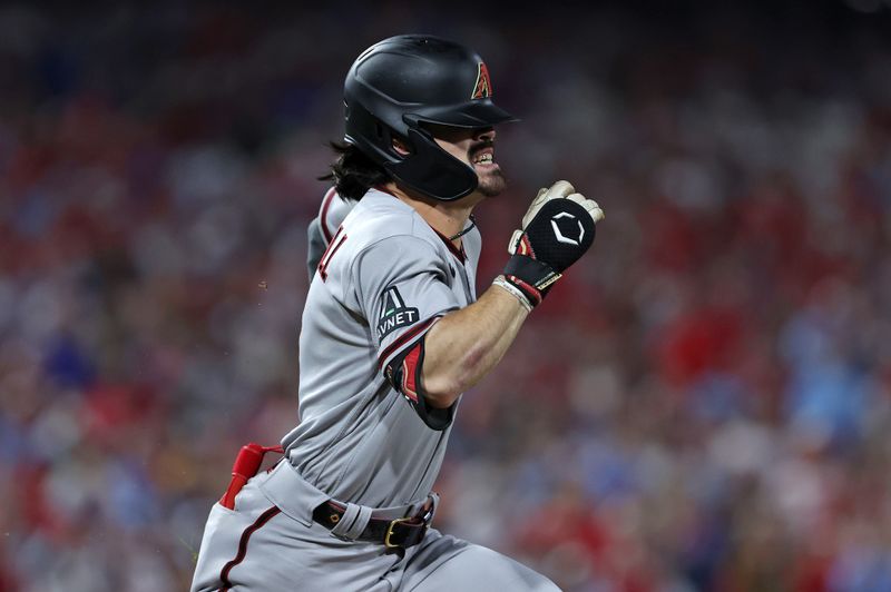 Oct 17, 2023; Philadelphia, Pennsylvania, USA; Arizona Diamondbacks left fielder Corbin Carroll (7) runs to first base on an error by the Philadelphia Phillies in the first inning for game two of the NLCS for the 2023 MLB playoffs at Citizens Bank Park. Mandatory Credit: Bill Streicher-USA TODAY Sports