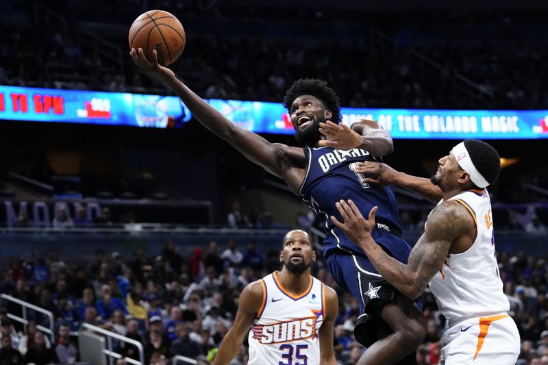 ORLANDO, FLORIDA - JANUARY 28: Jonathan Isaac #1 of the Orlando Magic goes up for a shot against Bradley Beal #3 of the Phoenix Suns during the fourth quarter at Kia Center on January 28, 2024 in Orlando, Florida. NOTE TO USER: User expressly acknowledges and agrees that, by downloading and or using this photograph, User is consenting to the terms and conditions of the Getty Images License Agreement. (Photo by Rich Storry/Getty Images)