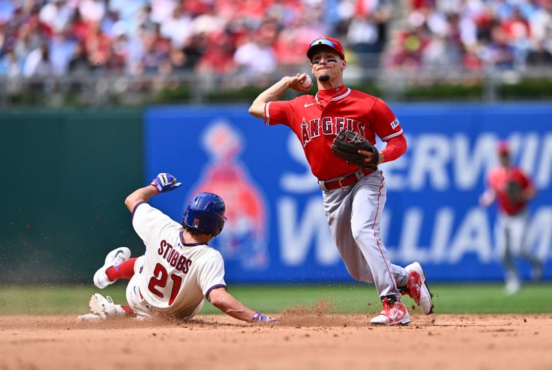 Aug 30, 2023; Philadelphia, Pennsylvania, USA; Los Angeles Angels shortstop Andrew Velazquez (4) turns a double play over Philadelphia Phillies catcher Garrett Stubbs (21) in the fourth inning at Citizens Bank Park. Mandatory Credit: Kyle Ross-USA TODAY Sports