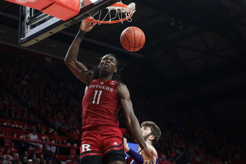 Mar 5, 2023; Piscataway, New Jersey, USA; Rutgers Scarlet Knights center Clifford Omoruyi (11) dunks the ball in front of Northwestern Wildcats forward Gus Hurlburt (54) during the second half at Jersey Mike's Arena. Mandatory Credit: Vincent Carchietta-USA TODAY Sports