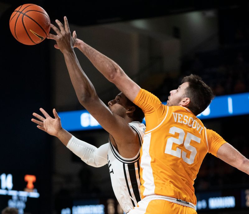 Feb 8, 2023; Nashville, Tennessee, USA;   Vanderbilt Commodores guard Jordan Wright (4) battles Tennessee Volunteers guard Santiago Vescovi (25) for the ball during the first half at Memorial Gymnasium.  Mandatory Credit: George Walker IV - USA TODAY Sports