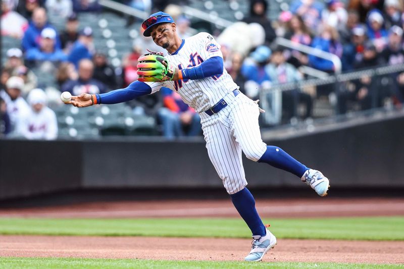 Apr 13, 2024; New York City, New York, USA;  New York Mets shortstop Francisco Lindor (12) makes an off balanced throw to first base for an assist in the first inning against the Kansas City Royals at Citi Field. Mandatory Credit: Wendell Cruz-USA TODAY Sports