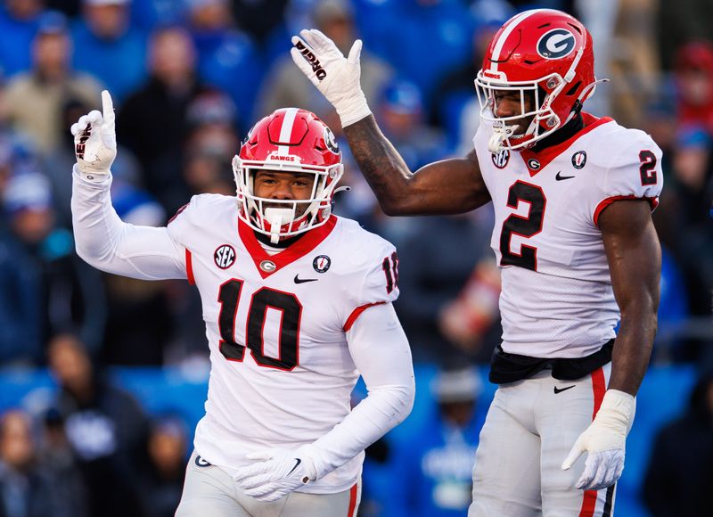 Nov 19, 2022; Lexington, Kentucky, USA; Georgia Bulldogs linebacker Jamon Dumas-Johnson (10) and linebacker Smael Mondon Jr. (2) celebrates during the first quarter against the Kentucky Wildcats at Kroger Field. Mandatory Credit: Jordan Prather-USA TODAY Sports