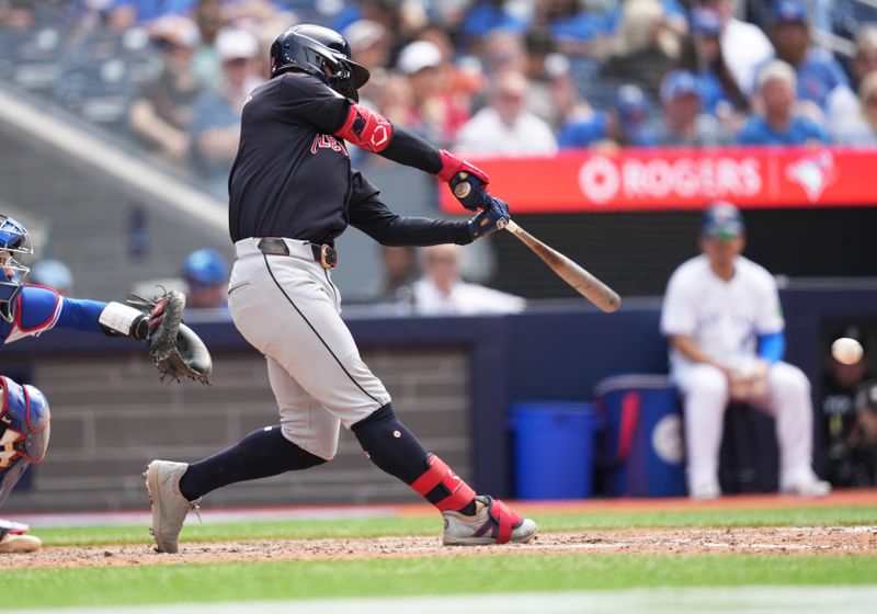 Jun 15, 2024; Toronto, Ontario, CAN; Cleveland Guardians second baseman Andres Gimenez (0) gets on first base on a fielders choice against the Toronto Blue Jays during the eighth inning at Rogers Centre. Mandatory Credit: Nick Turchiaro-USA TODAY Sports