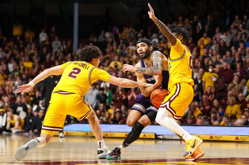 Feb 3, 2024; Minneapolis, Minnesota, USA; Northwestern Wildcats guard Boo Buie (0) drives as Minnesota Golden Gophers guard Mike Mitchell Jr. (2) and guard Elijah Hawkins (0) defend during overtime at Williams Arena. Mandatory Credit: Matt Krohn-USA TODAY Sports