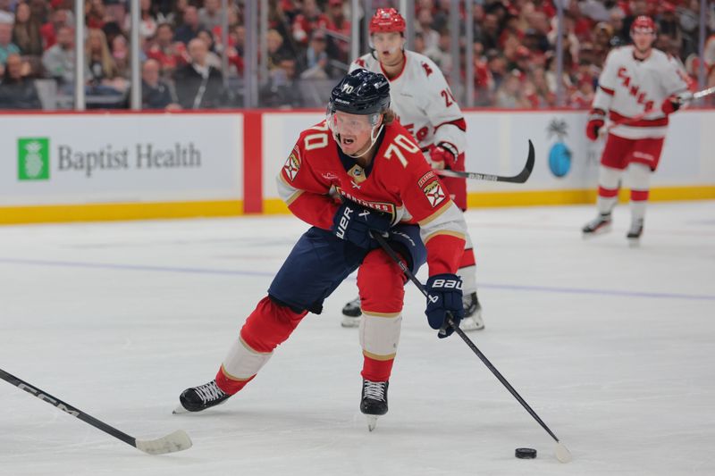 Nov 30, 2024; Sunrise, Florida, USA; Florida Panthers center Jesper Boqvist (70) moves the puck against the Carolina Hurricanes during the second period at Amerant Bank Arena. Mandatory Credit: Sam Navarro-Imagn Images