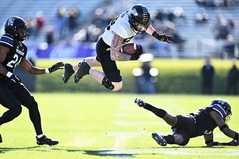 Nov 18, 2023; Evanston, Illinois, USA;  Purdue Boilermakers tight end Garrett Miller (88) is tripped up by Northwestern Wildcats defensive back Jaheem Joseph (3) after a pass reception in the second quarter at Ryan Field. Mandatory Credit: Jamie Sabau-USA TODAY Sports