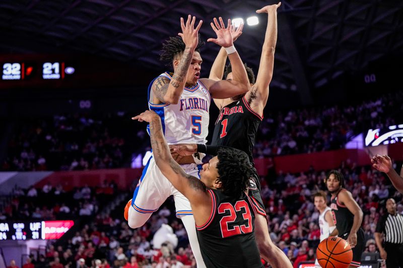 Feb 28, 2023; Athens, Georgia, USA; Florida Gators guard Will Richard (5) loses the ball in a collision with Georgia Bulldogs center Braelen Bridges (23) during the first half at Stegeman Coliseum. Mandatory Credit: Dale Zanine-USA TODAY Sports