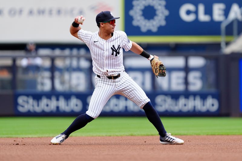 Aug 31, 2024; Bronx, New York, USA; New York Yankees shortstop Anthony Volpe (11) throws out St. Louis Cardinals shortstop Masyn Winn (not pictured) after fielding a ground ball during the first inning at Yankee Stadium. Mandatory Credit: Gregory Fisher-USA TODAY Sports