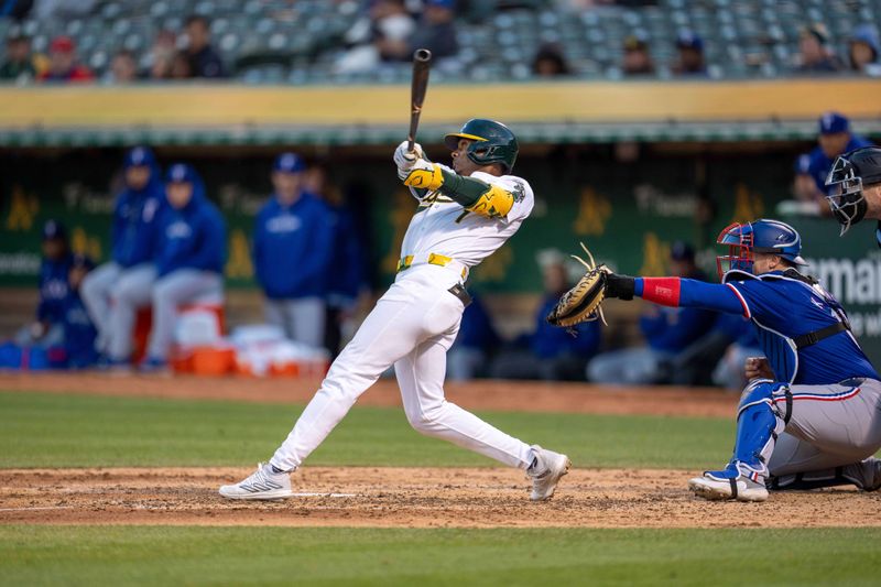 May 6, 2024; Oakland, California, USA; Oakland Athletics outfielder Esteury Ruiz (1) hits a RBI sacrifice fly against the Texas Rangers during the fifth inning at Oakland-Alameda County Coliseum. Mandatory Credit: Neville E. Guard-USA TODAY Sports