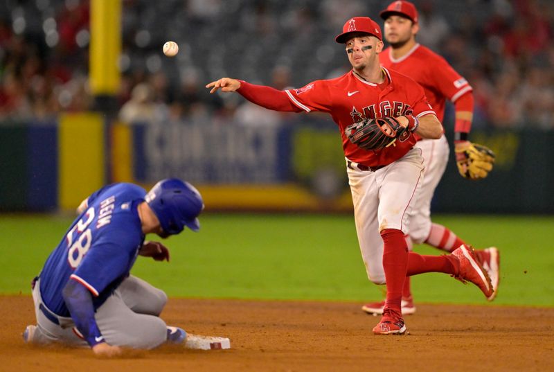 Sep 27, 2023; Anaheim, California, USA;  Texas Rangers catcher Jonah Heim (28) is out at second as Los Angeles Angels shortstop Zach Neto (9) throws to first to complete a double play in the sixth inning at Angel Stadium. Mandatory Credit: Jayne Kamin-Oncea-USA TODAY Sports