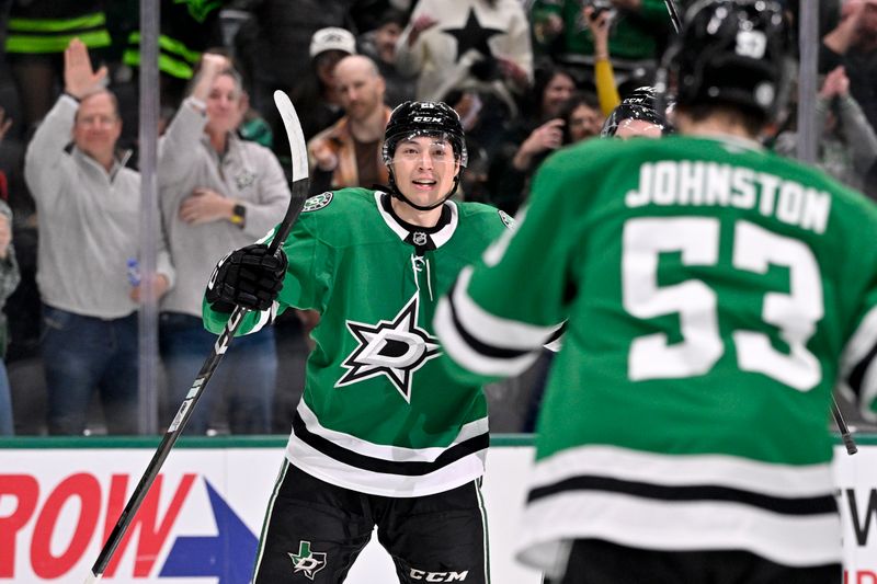 Jan 31, 2025; Dallas, Texas, USA; Dallas Stars left wing Jason Robertson (21) and center Wyatt Johnston (53) celebrates a power play goal scored by Robertson against the Vancouver Canucks during the second period at the American Airlines Center. Mandatory Credit: Jerome Miron-Imagn Images