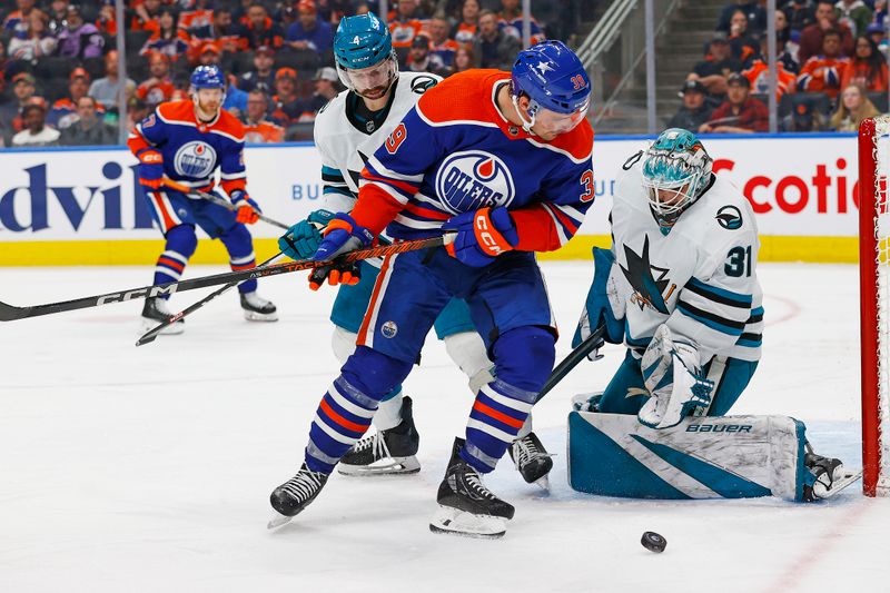 Apr 15, 2024; Edmonton, Alberta, CAN; Edmonton Oilers forward Sam Carrick (39) looks for a rebound in front of San Jose Sharks goaltender Georgi Romanov (31) during the third period at Rogers Place. Mandatory Credit: Perry Nelson-USA TODAY Sports