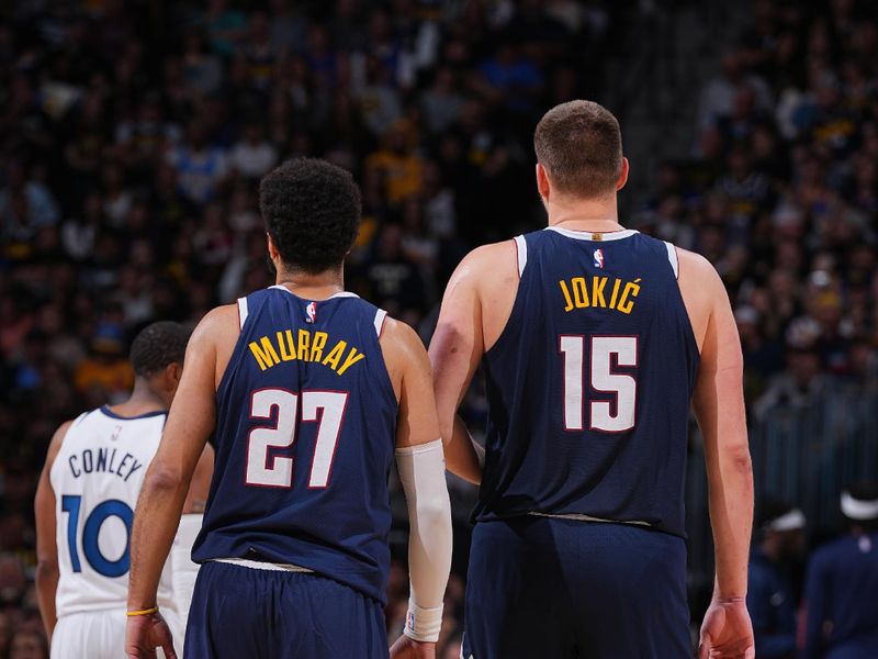 DENVER, CO - APRIL 10: Jamal Murray #27 of the Denver Nuggets and Nikola Jokic #15 look on during the game against the Minnesota Timberwolves on April 10, 2024 at the Ball Arena in Denver, Colorado. NOTE TO USER: User expressly acknowledges and agrees that, by downloading and/or using this Photograph, user is consenting to the terms and conditions of the Getty Images License Agreement. Mandatory Copyright Notice: Copyright 2024 NBAE (Photo by Bart Young/NBAE via Getty Images)
