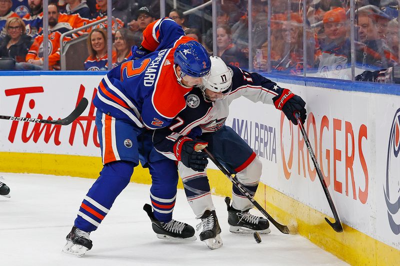 Jan 23, 2024; Edmonton, Alberta, CAN; Edmonton Oilers 2 and Columbus Blue Jackets forward Justin Danforth (17) Battle along the boards for a loose puck during the second period at Rogers Place. Mandatory Credit: Perry Nelson-USA TODAY Sports