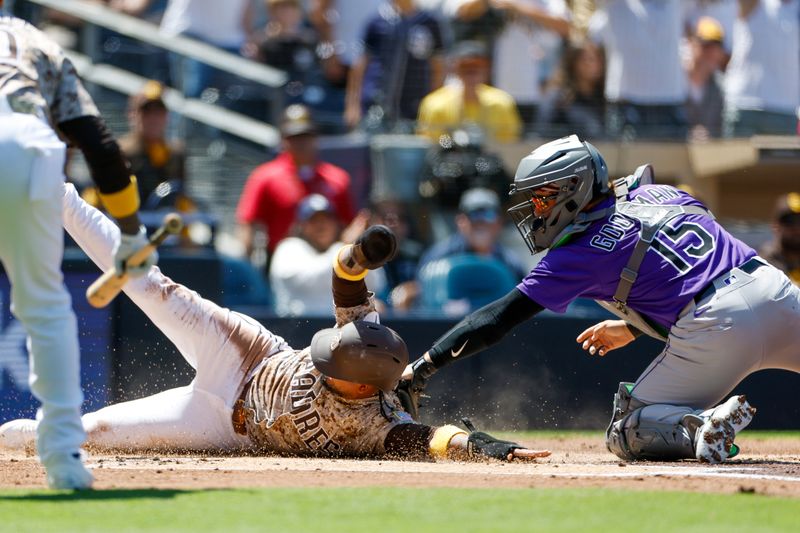 Apr 13, 2025; San Diego, California, USA; San Diego Padres designated hitter Luis Arraez (4) slides under the tag of Colorado Rockies Colorado Rockies catcher Hunter Goodman (15) to score a run during the first inning against the Colorado Rockies at Petco Park. Mandatory Credit: David Frerker-Imagn Images