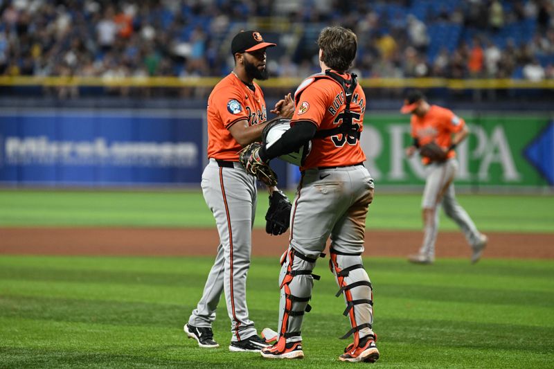 Aug 10, 2024; St. Petersburg, Florida, USA; Baltimore Orioles relief pitcher Sereanthony Dominguez (56) and catcher Adley Rutschmann (35) celebrate after defeating Tampa Bay Rays at Tropicana Field. Mandatory Credit: Jonathan Dyer-USA TODAY Sports