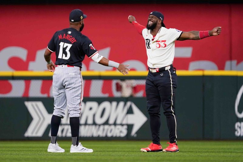 Aug 16, 2024; Arlington, Texas, USA; Minnesota Twins outfielder Manuel Margot (13) and Texas Rangers outfielder Adolis García (53) stretch prior to a game at Globe Life Field. Mandatory Credit: Raymond Carlin III-USA TODAY Sports