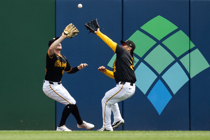 May 5, 2024; Pittsburgh, Pennsylvania, USA; Pittsburgh Pirates center fielder Jack Suwinski (65) and right fielder Connor Joe (2) chase after a ball for the first out of the sixth inning against the Colorado Rockies at PNC Park. Mandatory Credit: Scott Galvin-USA TODAY Sports